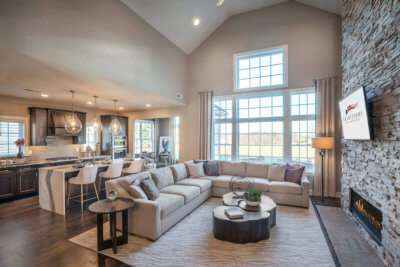 Living room with large sectional couch and fire place from Traditions of America
