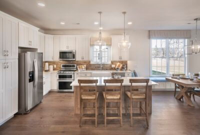 Kitchen with white cabinets and a center island in the washington model