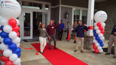 People cutting the ribbon at the east petersburg community clubhouse