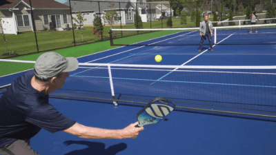 active adult community residents playing pickleball