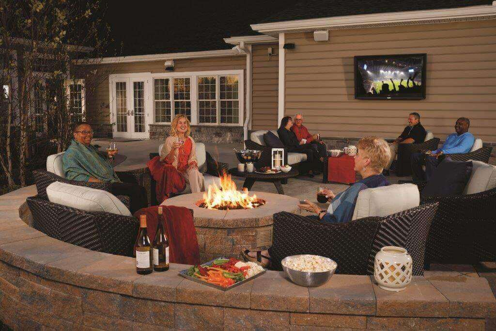 People sitting outside the community clubhouse enjoying the Firepit & Wine