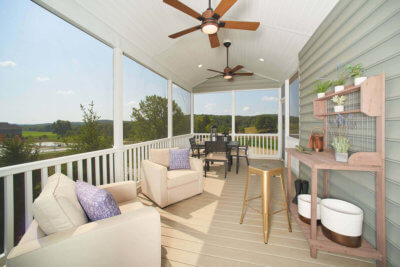 Screened porch with furniture in a Traditions of America home
