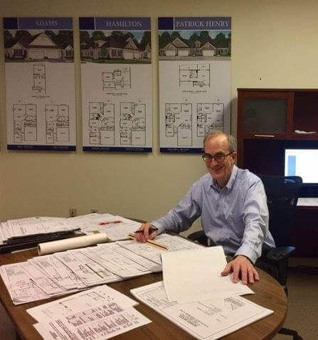 Scott Botel-Barnard looking over plans at his desk