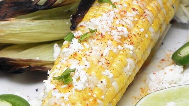 Photo of corn on the cob with cheese and butter
