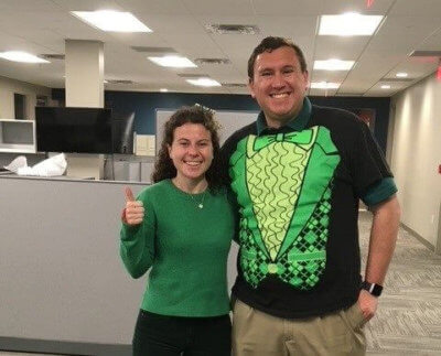 Two employees dressed up in green on st patricks day