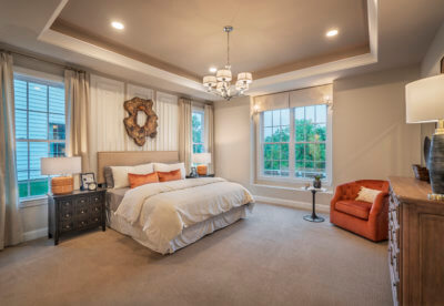 Master bedroom in the betsy ross model with a seating area