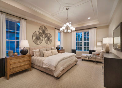Master bedroom with a couch and chandelier in the Washington Model