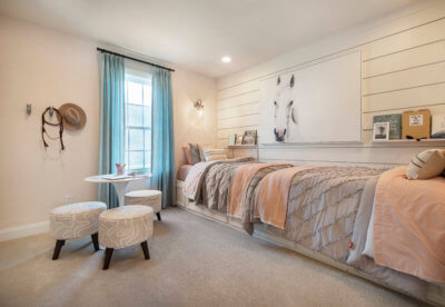 Bedroom with two foot to foot twin beds in the Washington Model