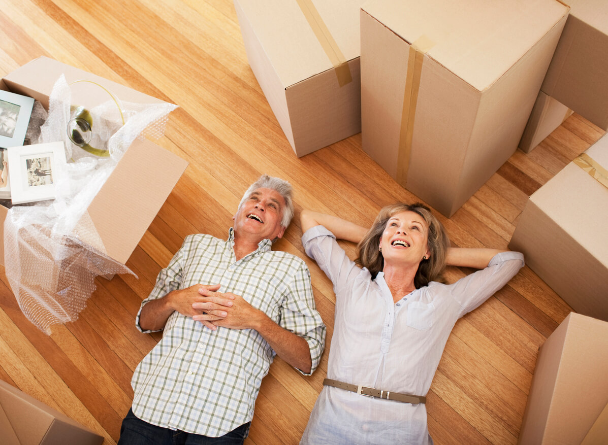 55+ couple taking a break on moving day