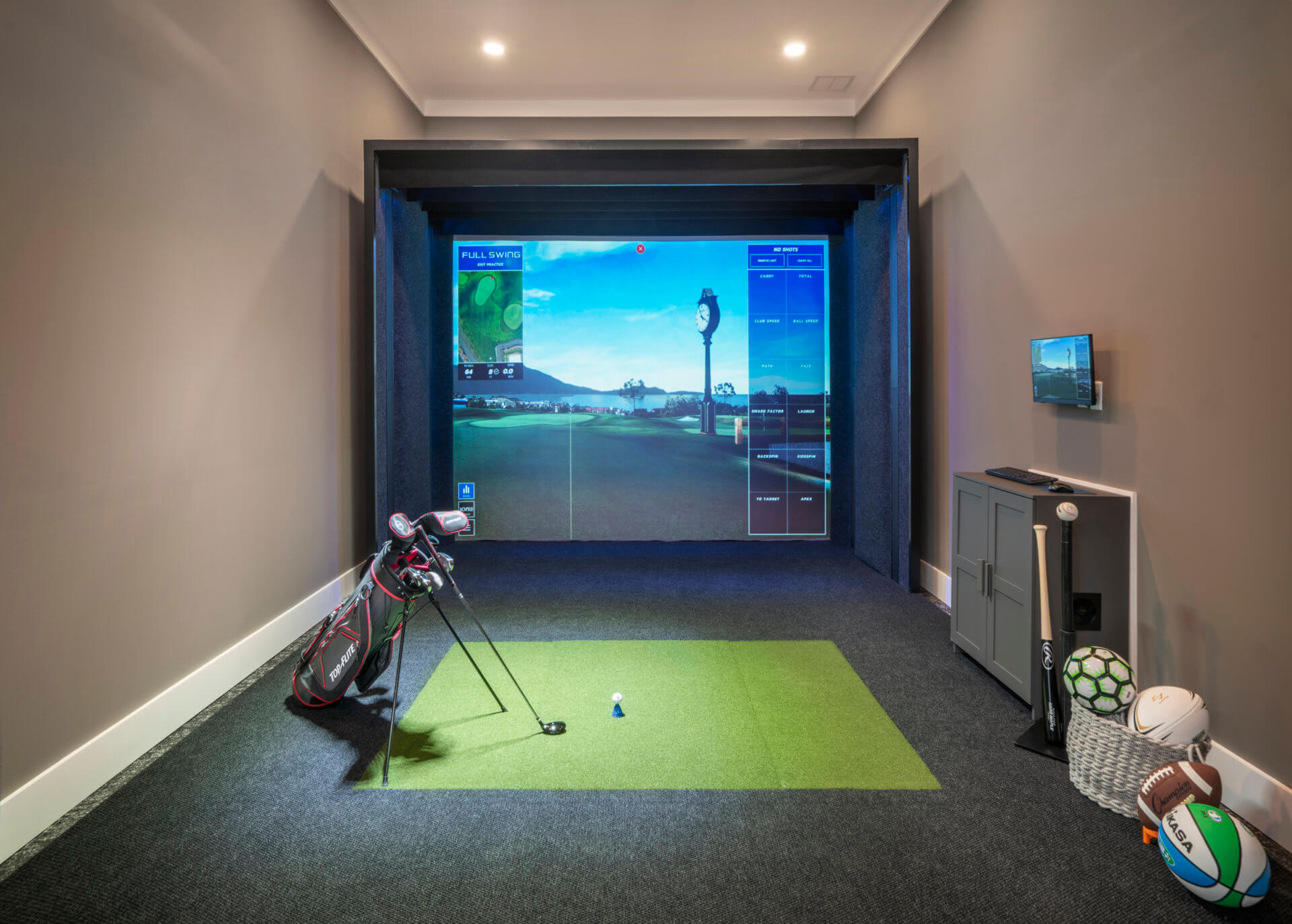 Golf Simulator room with other sports equipment to the side