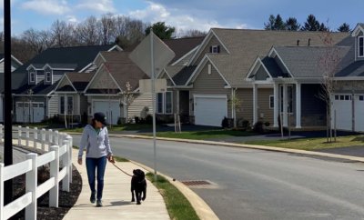Woman and Dog walking in Traditions of America Community