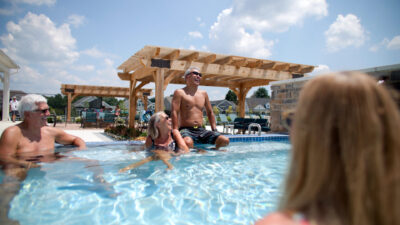 Active adults sitting and laughing in the hot tub in chesterfield