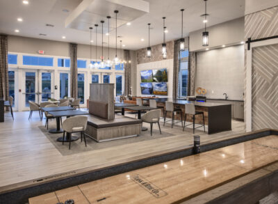 Dining area and gaming lounge in a traditions of america community clubhouse