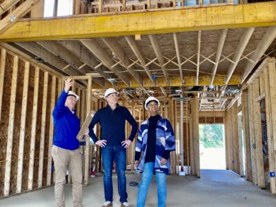 People standing in a under construction home