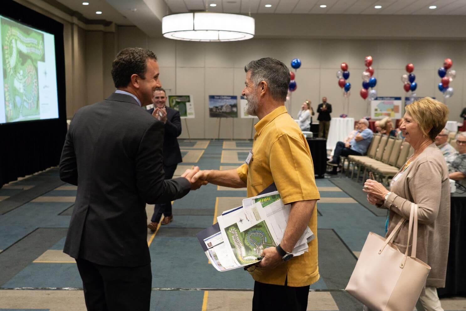 People shaking hands at a traditions of America event