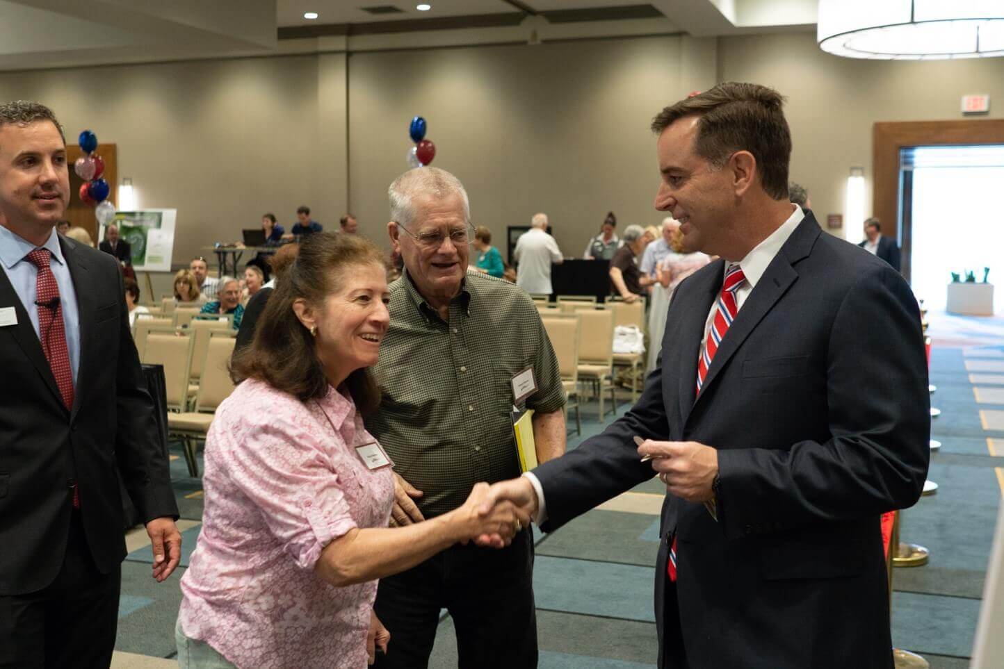People shaking hands at a traditions of America event