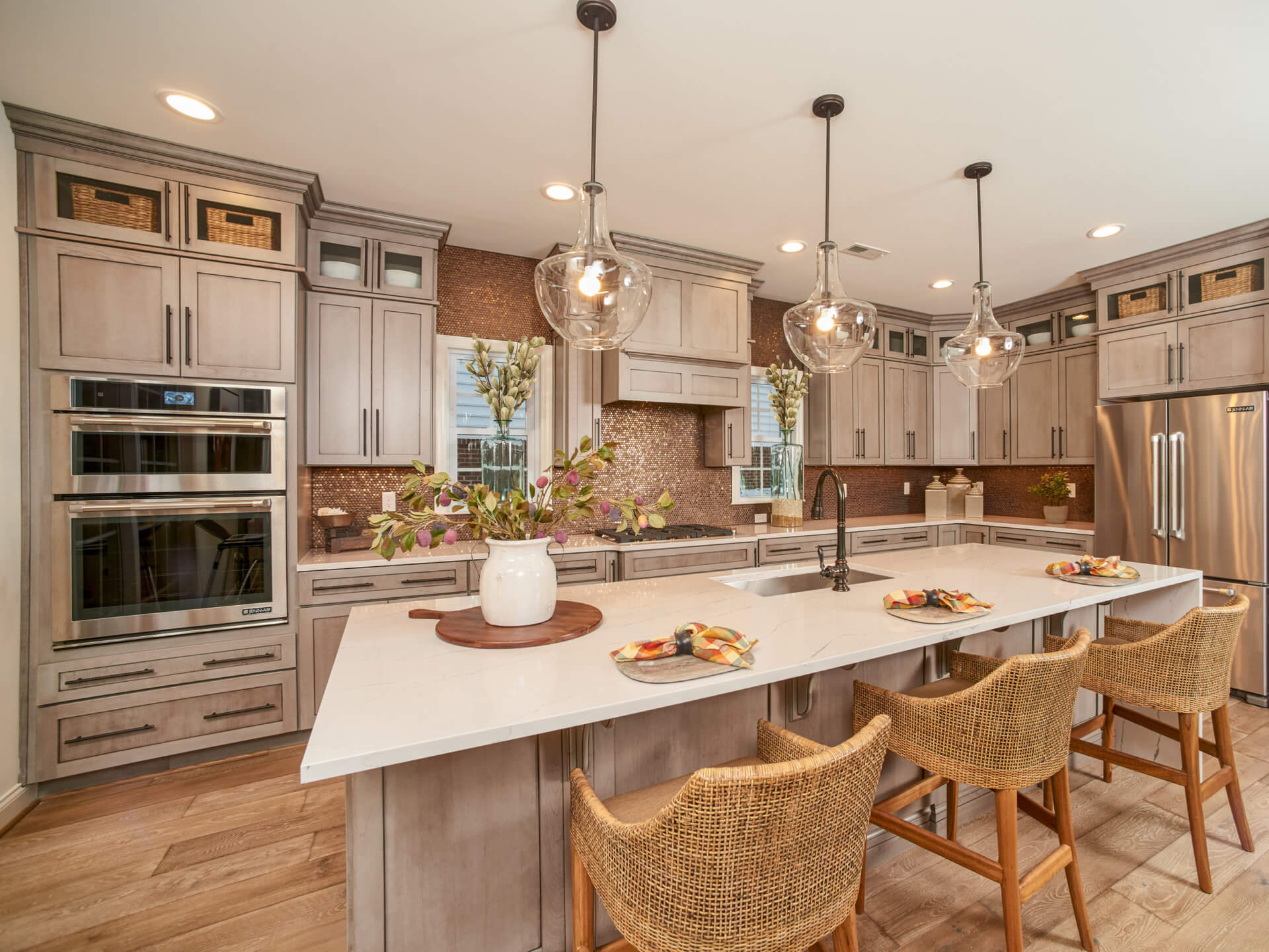 Kitchen with center island with sink in it in a traditions of America home