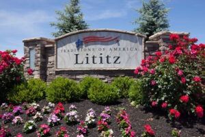 Traditions of America Lititz Community sign with flower bed