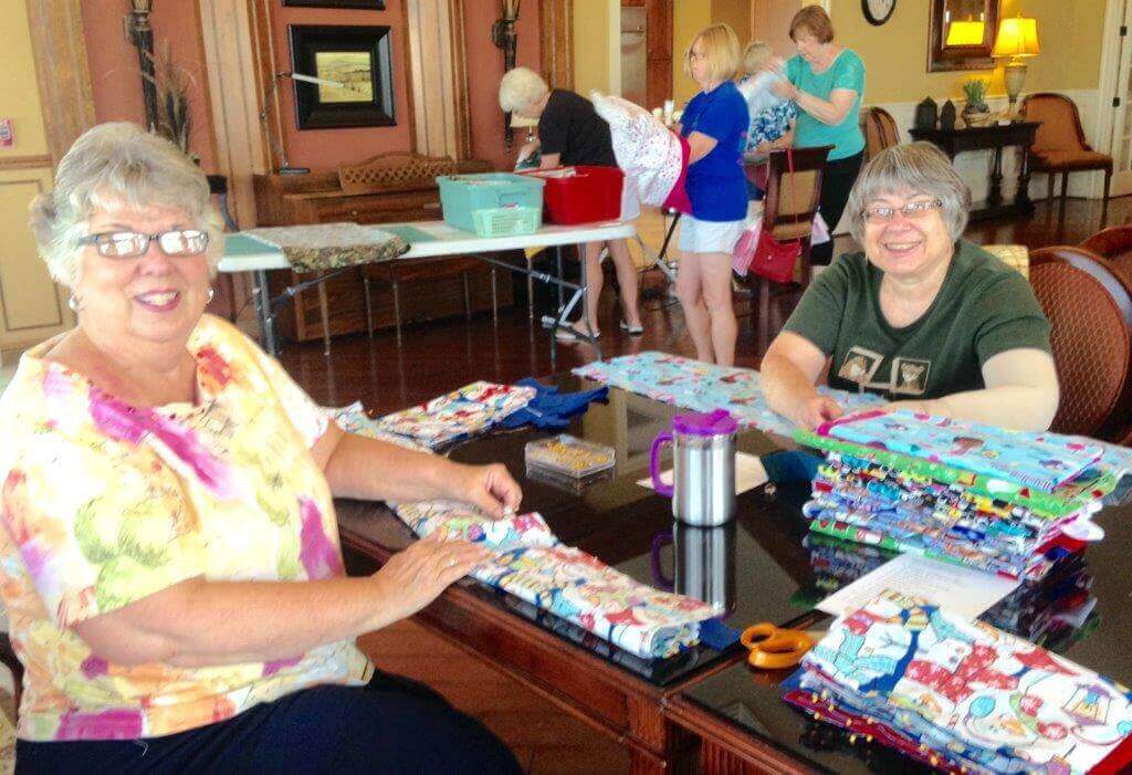 People working together to make home made covid supplies