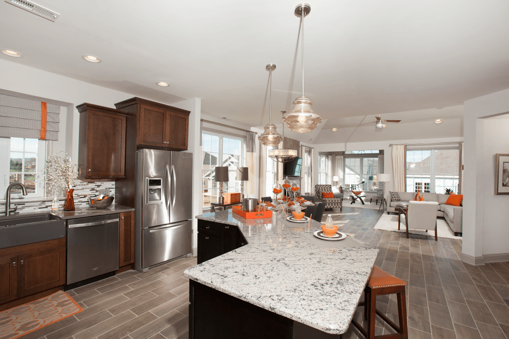 Kitchen with brown cabinets with center island from Traditions of America