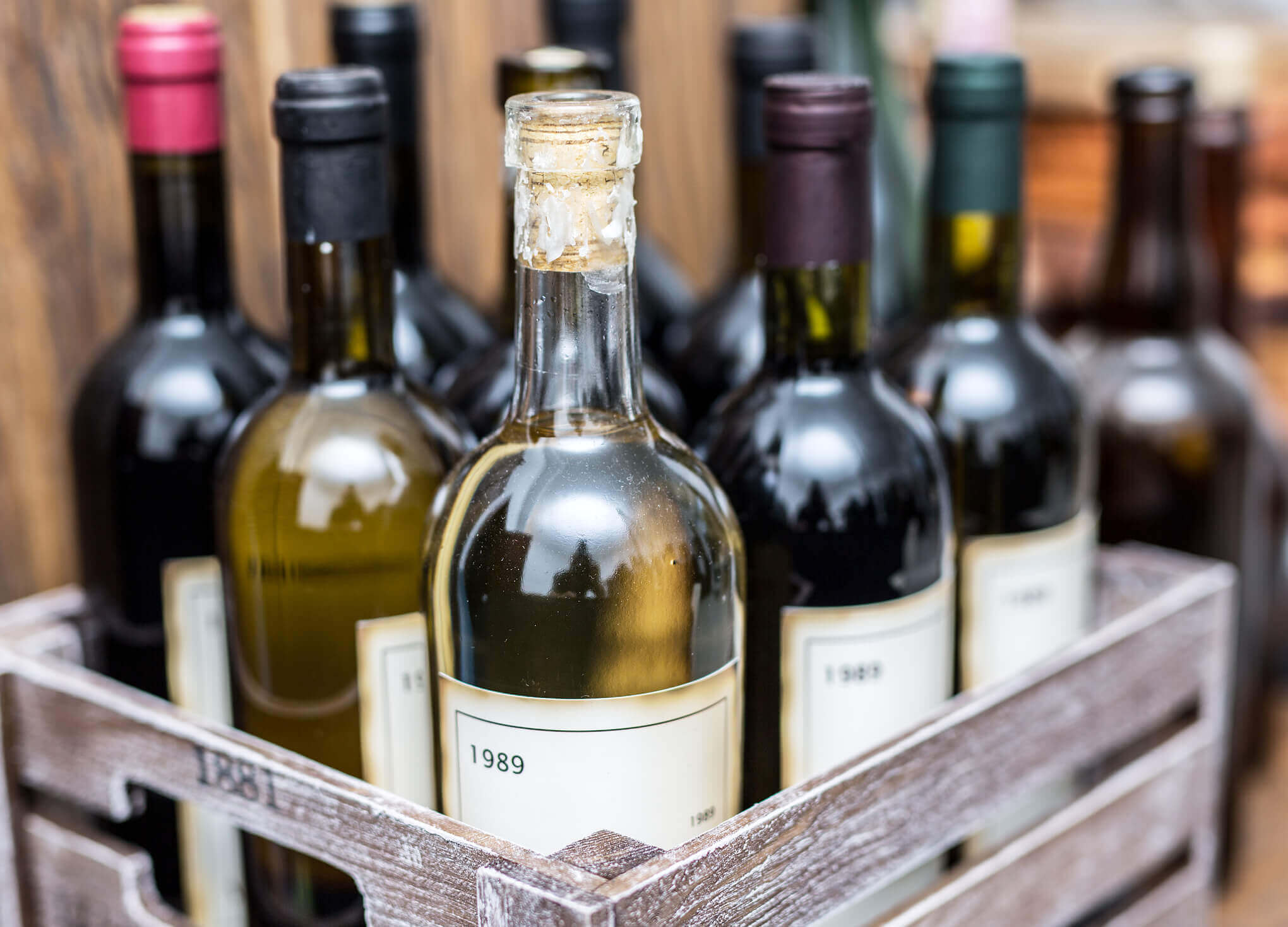 Old wine bottles in a wooden crate.