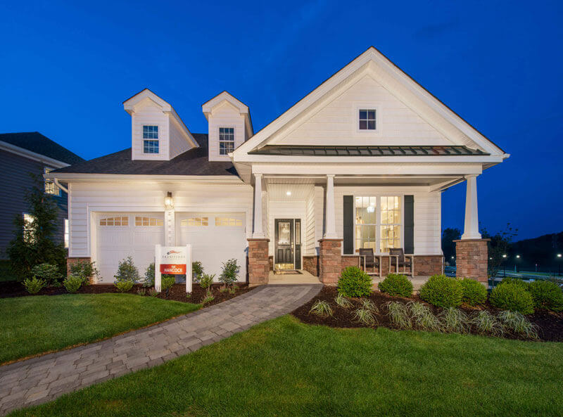 The Hancock Model with White Siding and Brick Accents